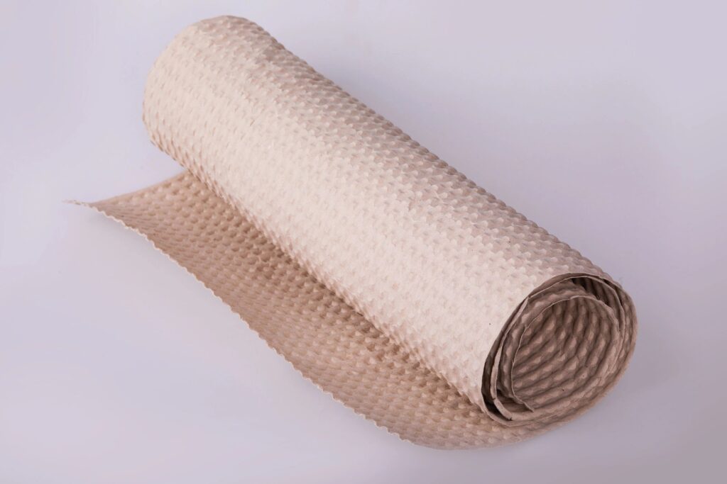 Roll of beige wrapping paper on a white background.