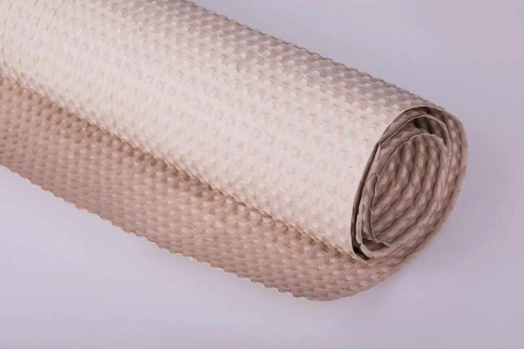 Roll of beige wrapping paper on a white background.