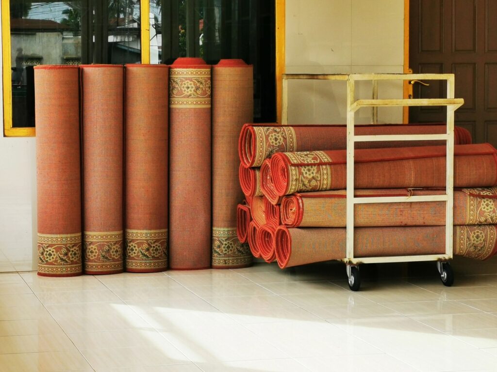Group of rolled carpets arranged in the corner of the room